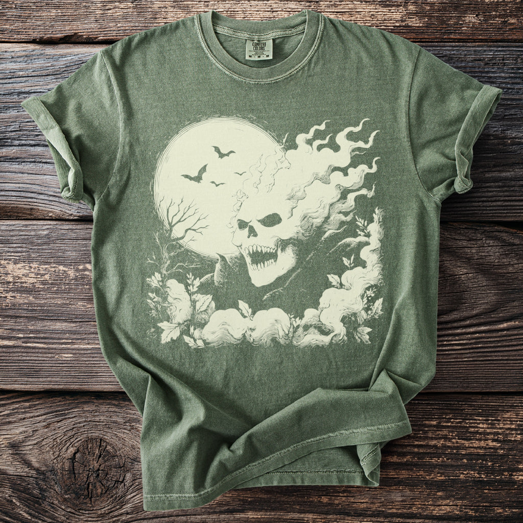 Green t-shirt with a cream-colored graphic of a flaming skull, bats, and a moon.