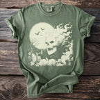 Green t-shirt with a cream-colored graphic of a flaming skull, bats, and a moon.