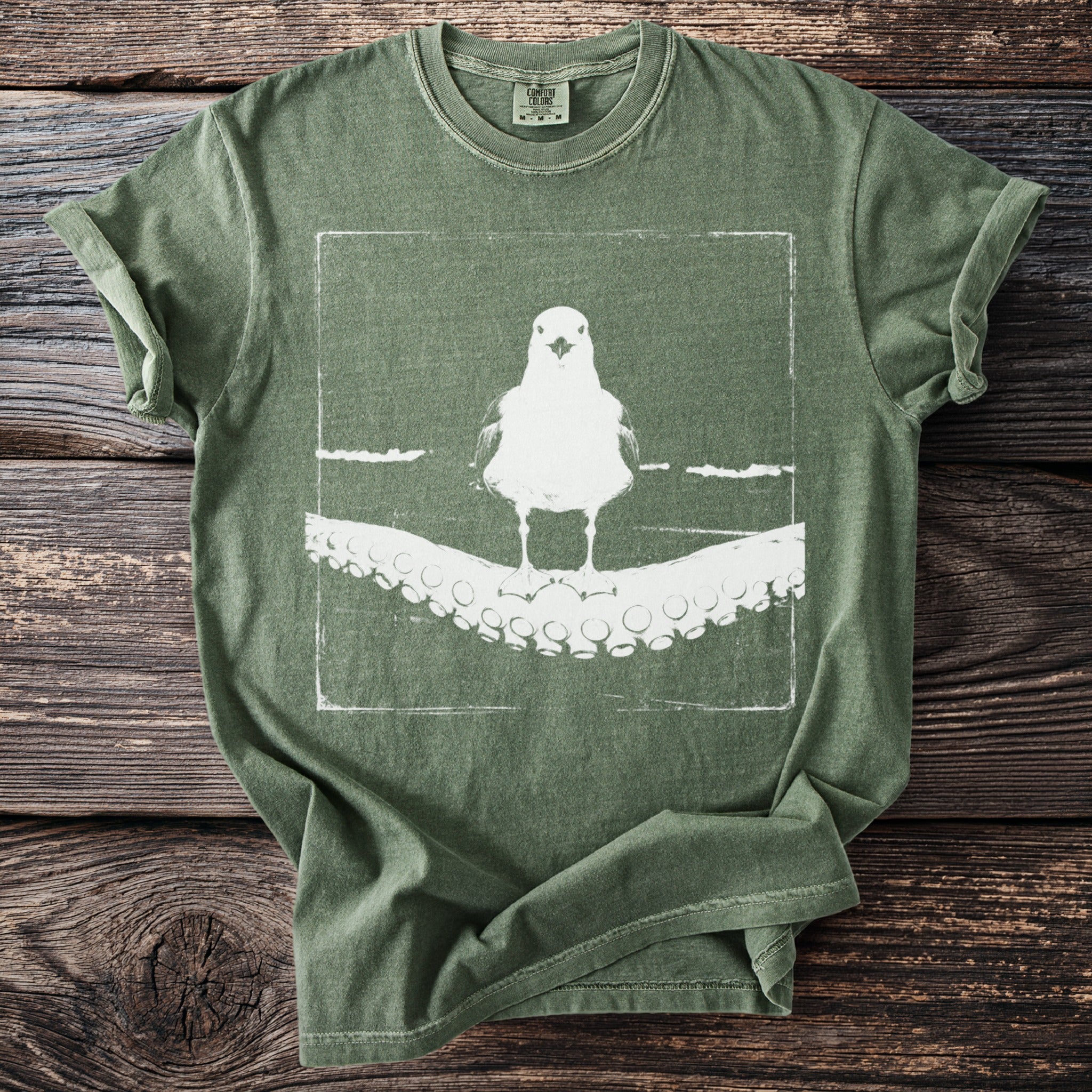 Green t-shirt with white graphic of a seagull on an octopus tentacle.