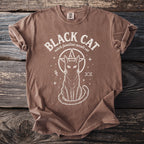 Brown t-shirt with white graphic of a black cat, pentagram, and occult symbols.