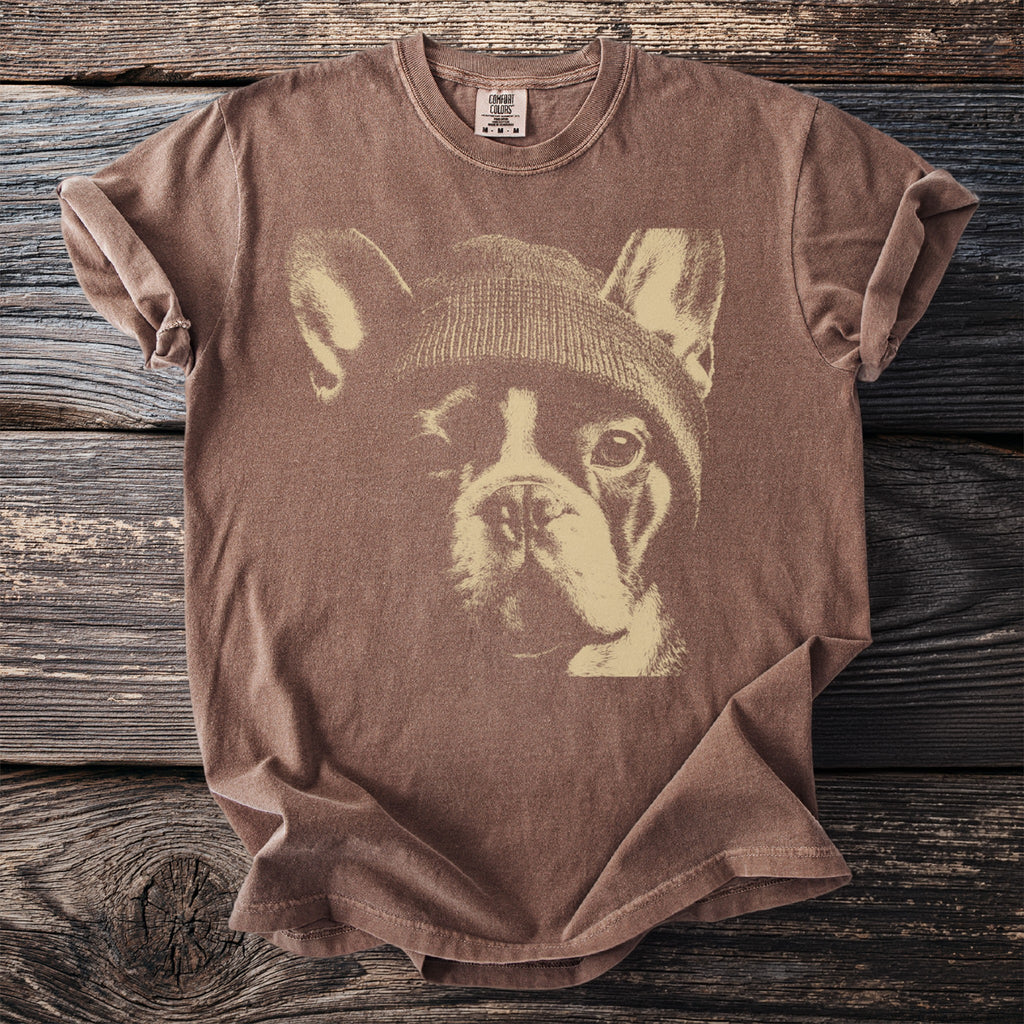 Brown t-shirt with a graphic of a French bulldog wearing a beanie.