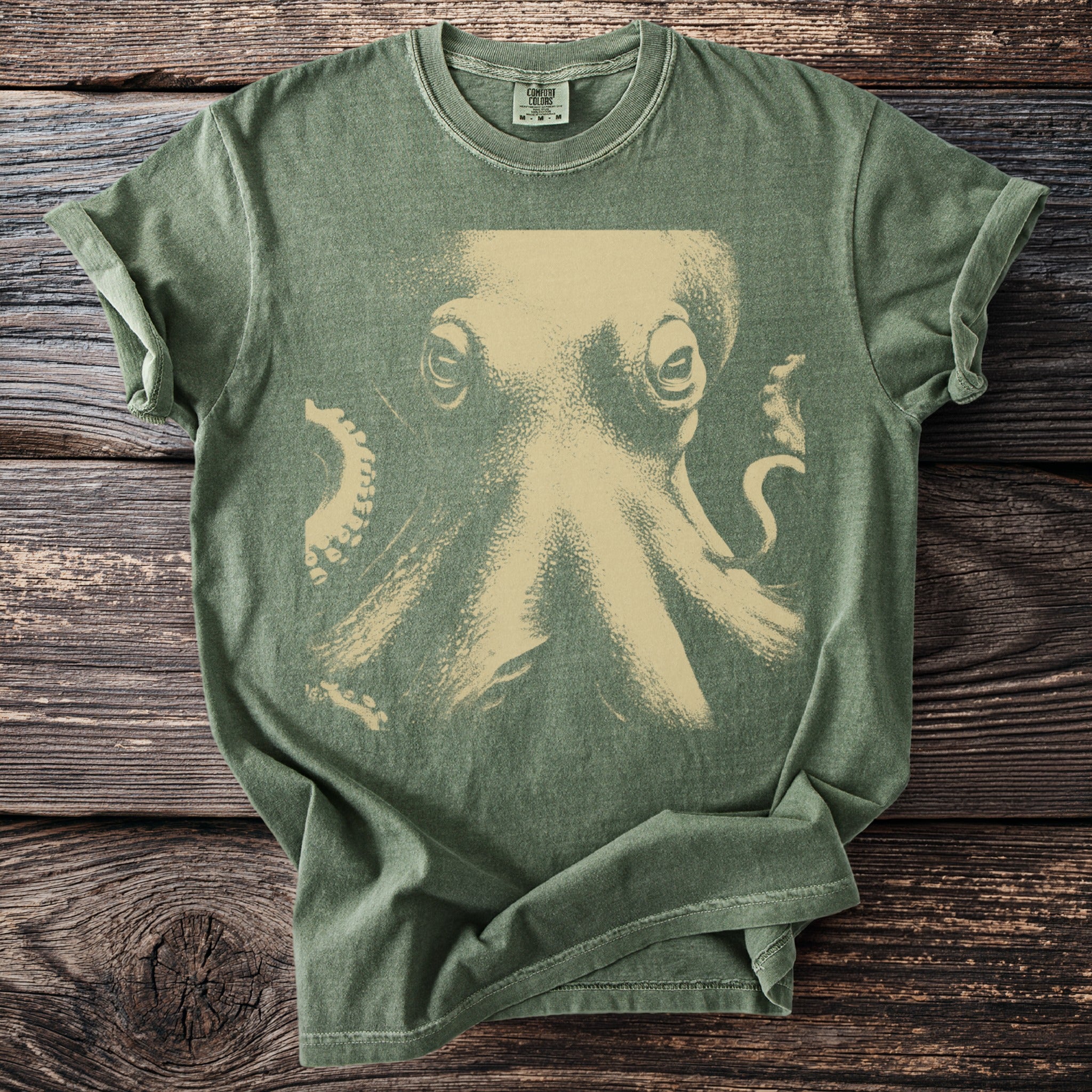 Green t-shirt with a vintage tan octopus graphic and Comfort Colors tag.