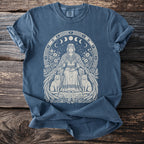 Blue t-shirt with regal woman, cats, moons, and runes graphic design.
