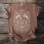 Brown t-shirt with a mystical graphic of hands, crystal ball, and celestial moon phases.