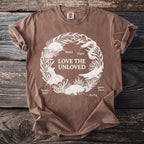 Brown t-shirt with white print of "Love the Unloved" encircled by sea creatures.