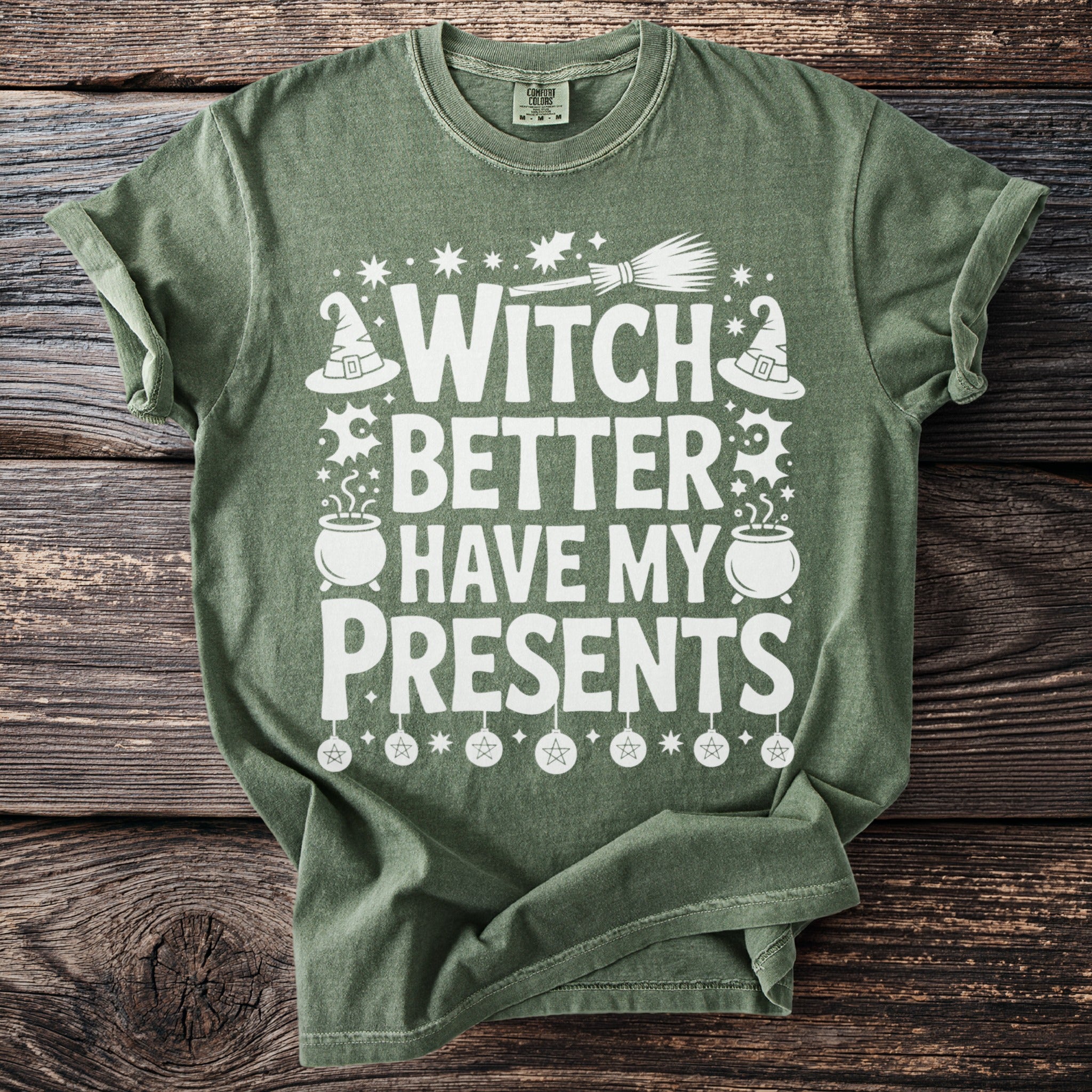 Green t-shirt with white text "Witch Better Have My Presents" and Halloween graphics.