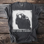Dark grey t-shirt with a black and white crow graphic and text that reads "the crows remember".