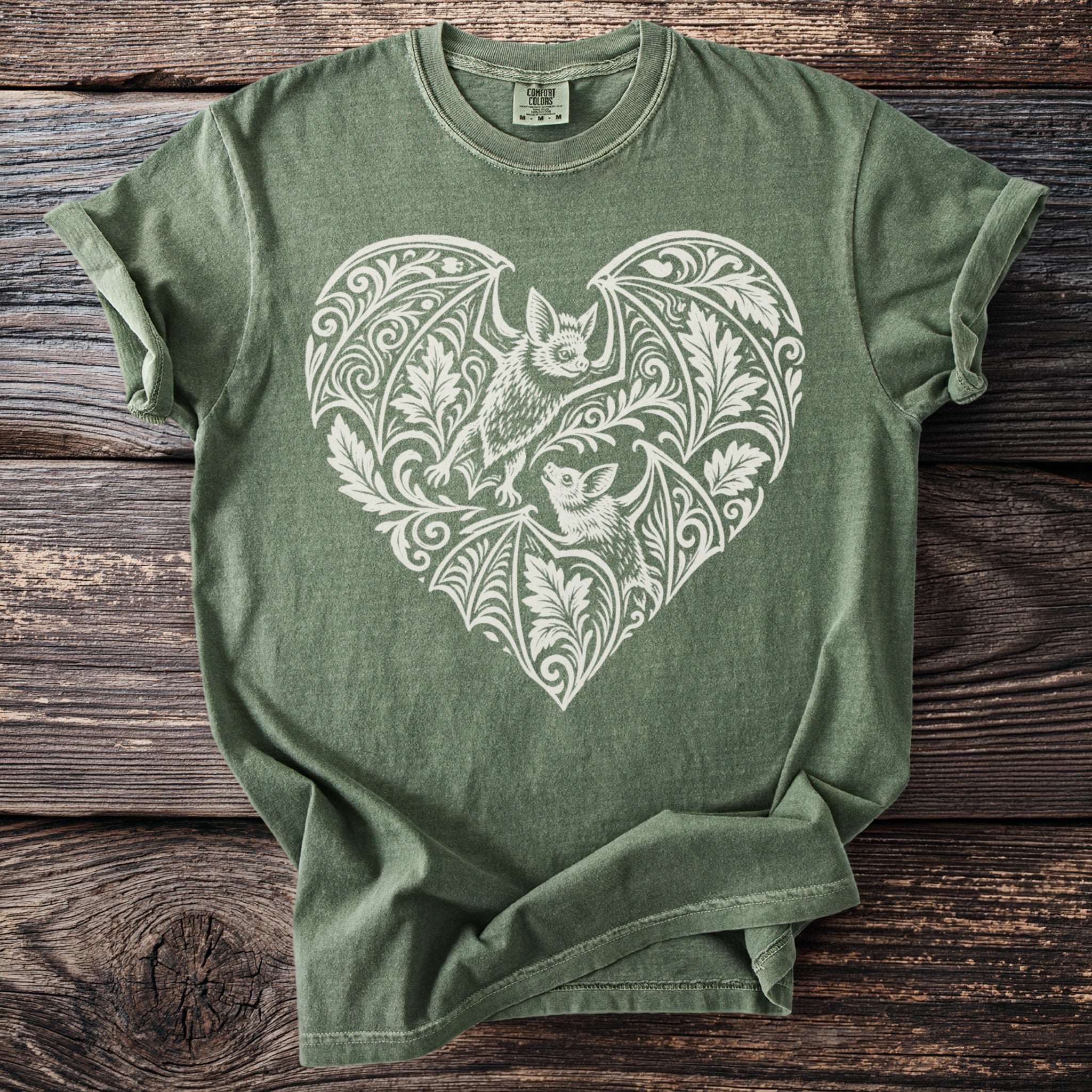 Green t-shirt with a white bat and floral heart design