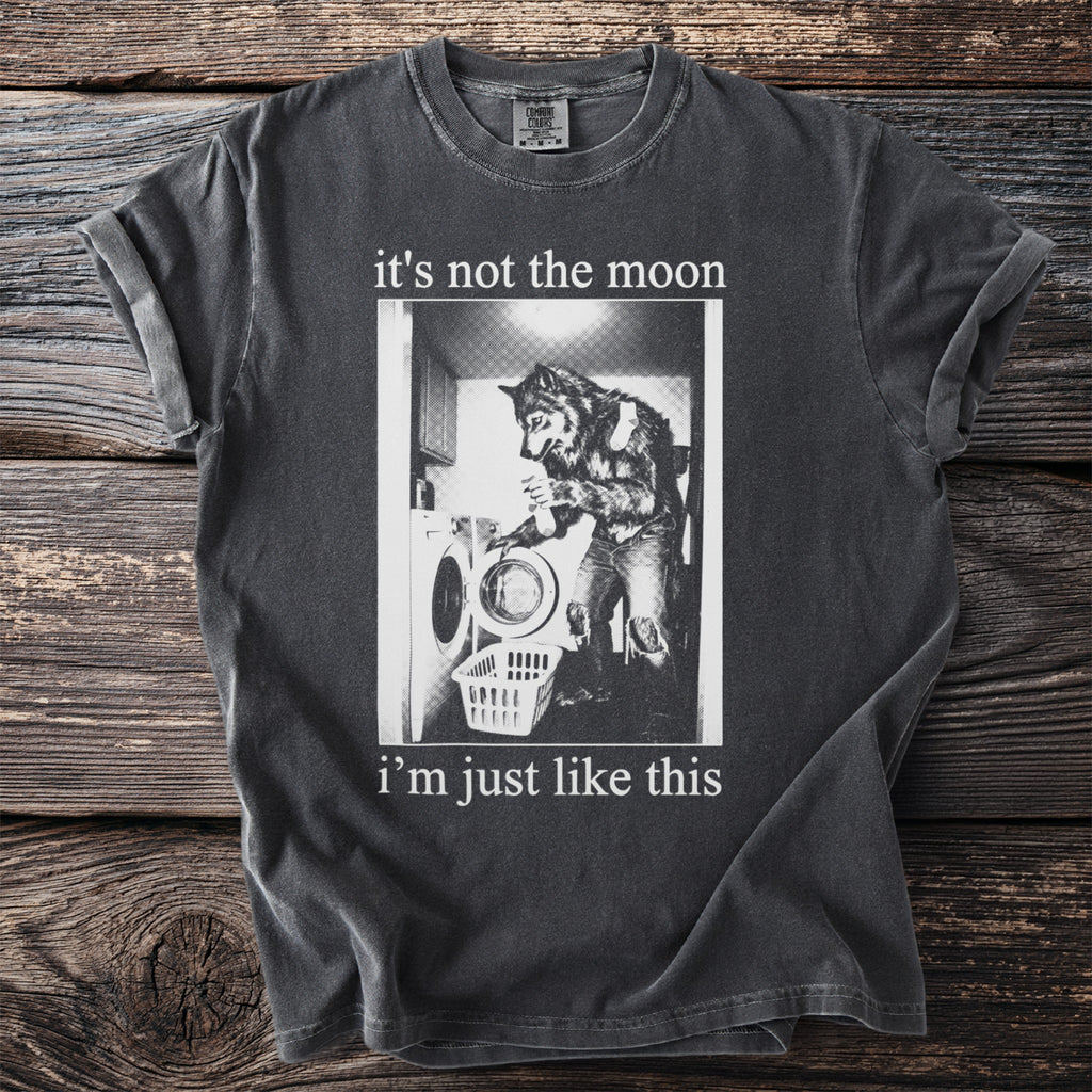 Dark gray t-shirt with graphic of werewolf doing laundry and text "it's not the moon i'm just like this".