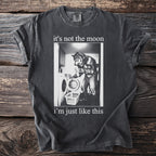 Dark gray t-shirt with graphic of werewolf doing laundry and text "it's not the moon i'm just like this".