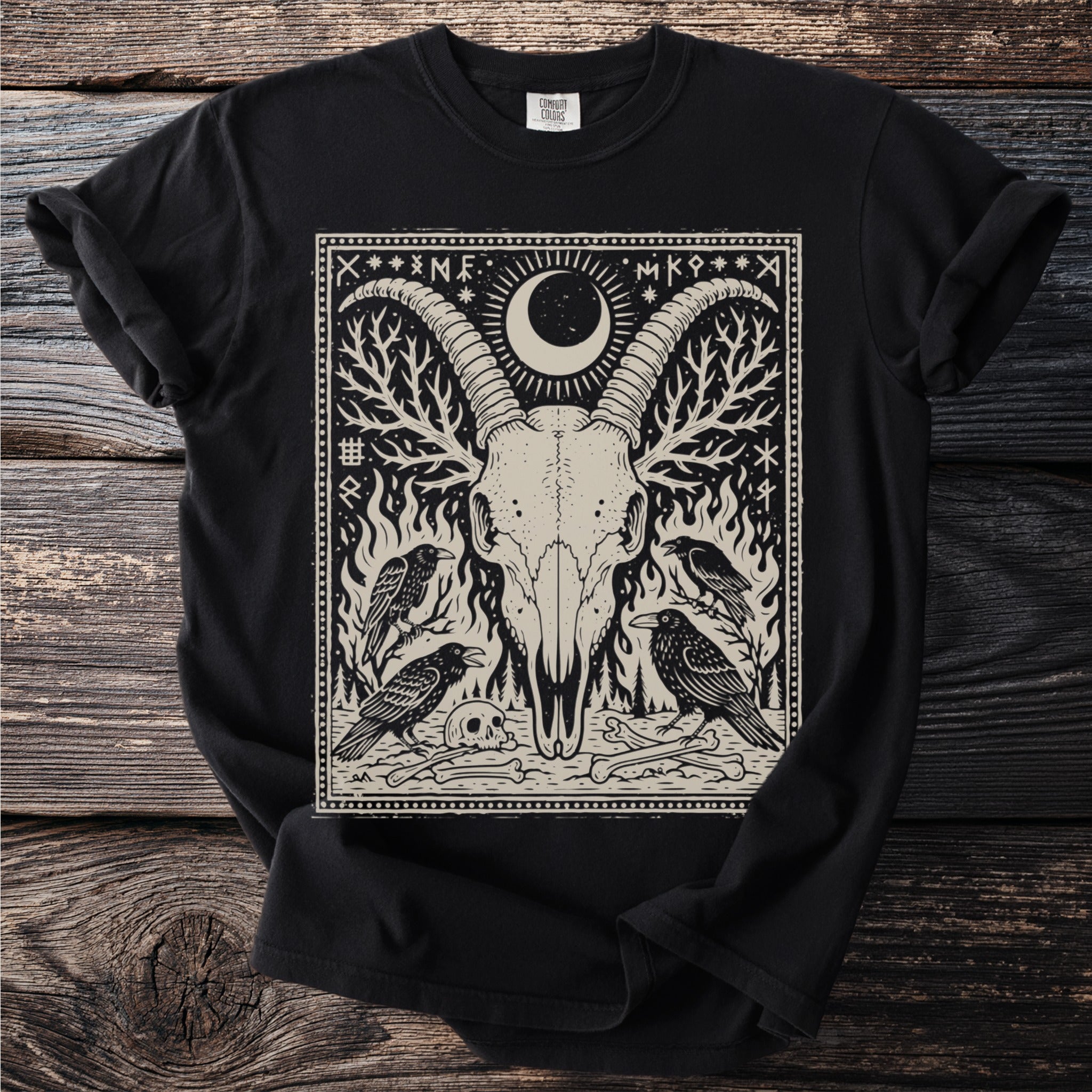 Black t-shirt featuring a print of a ram skull, crows, and runes within a border.