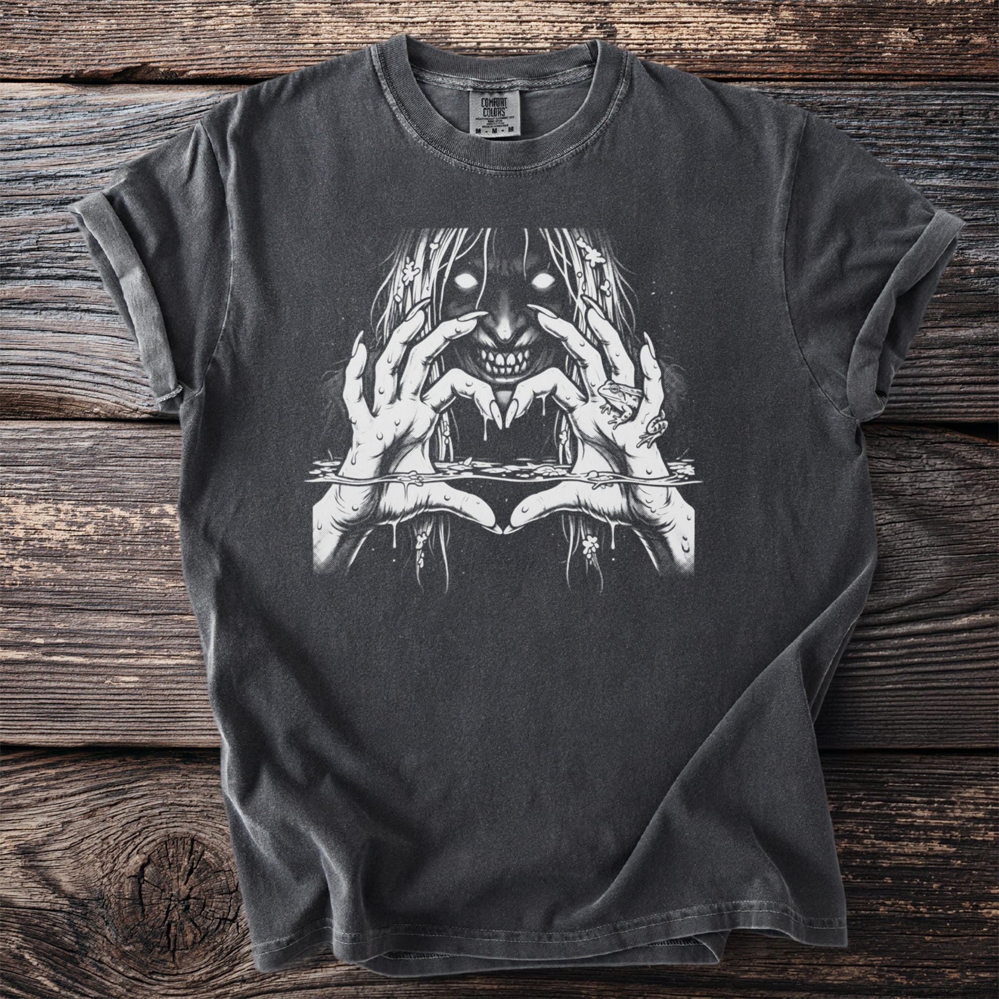 Dark t-shirt with a white graphic of a ghostly figure making a heart shape with its hands.
