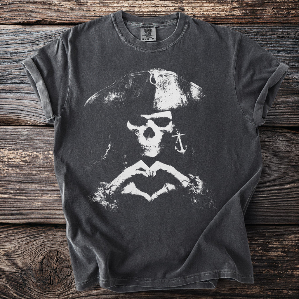 Dark t-shirt with distressed white pirate skull, anchor earring, and heart hands graphic.