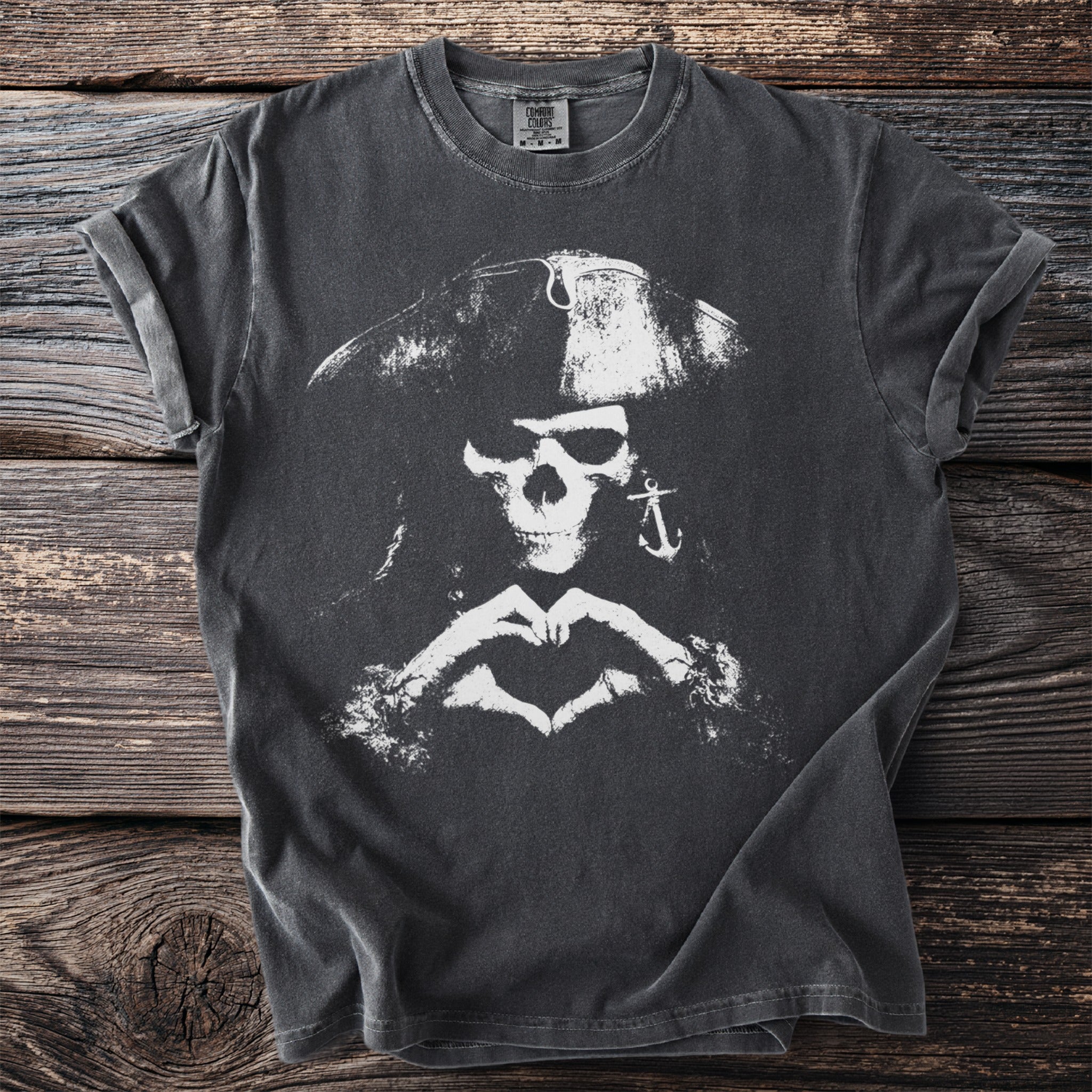 Dark t-shirt with distressed white pirate skull, anchor earring, and heart hands graphic.
