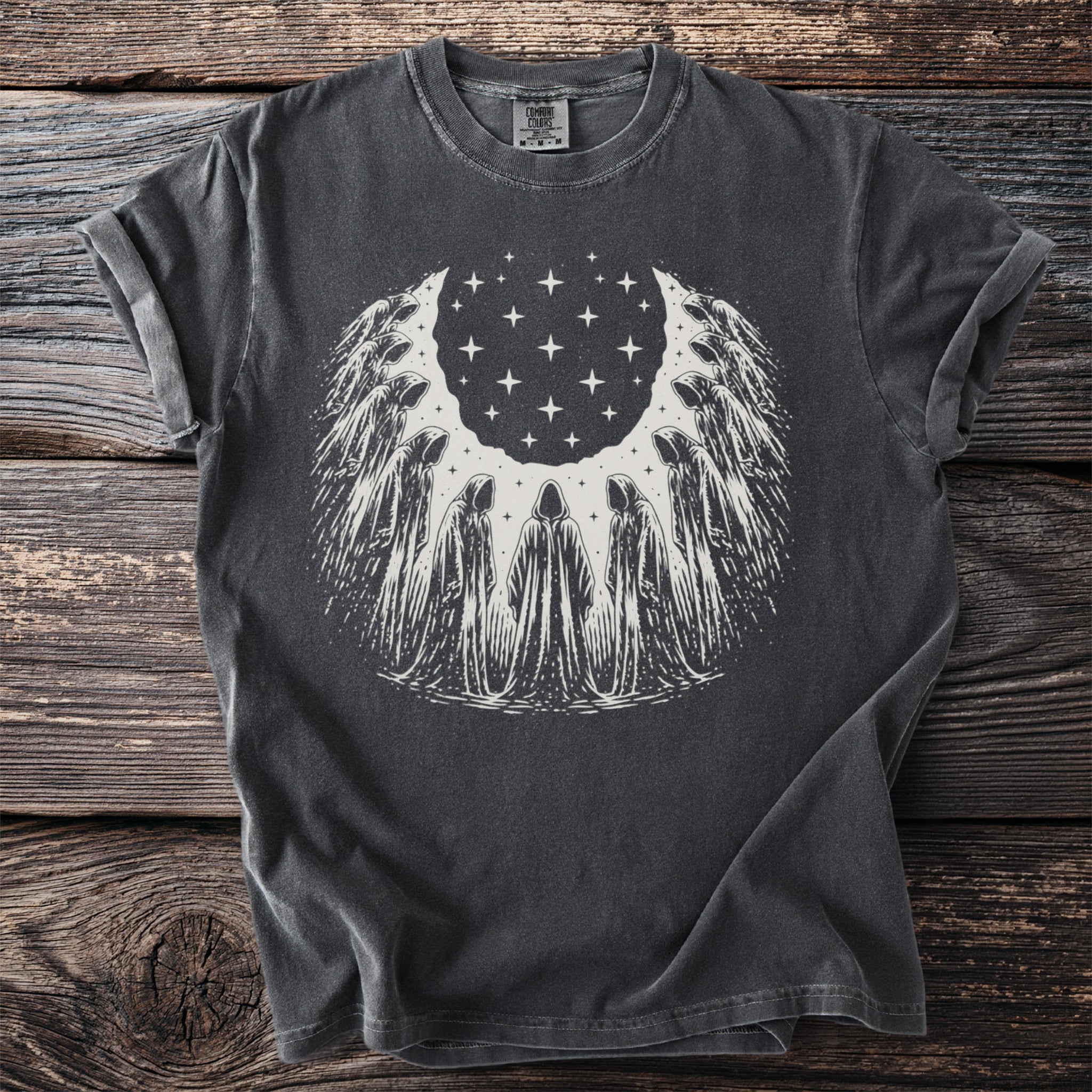Dark t-shirt with a circle of hooded figures and stars design.