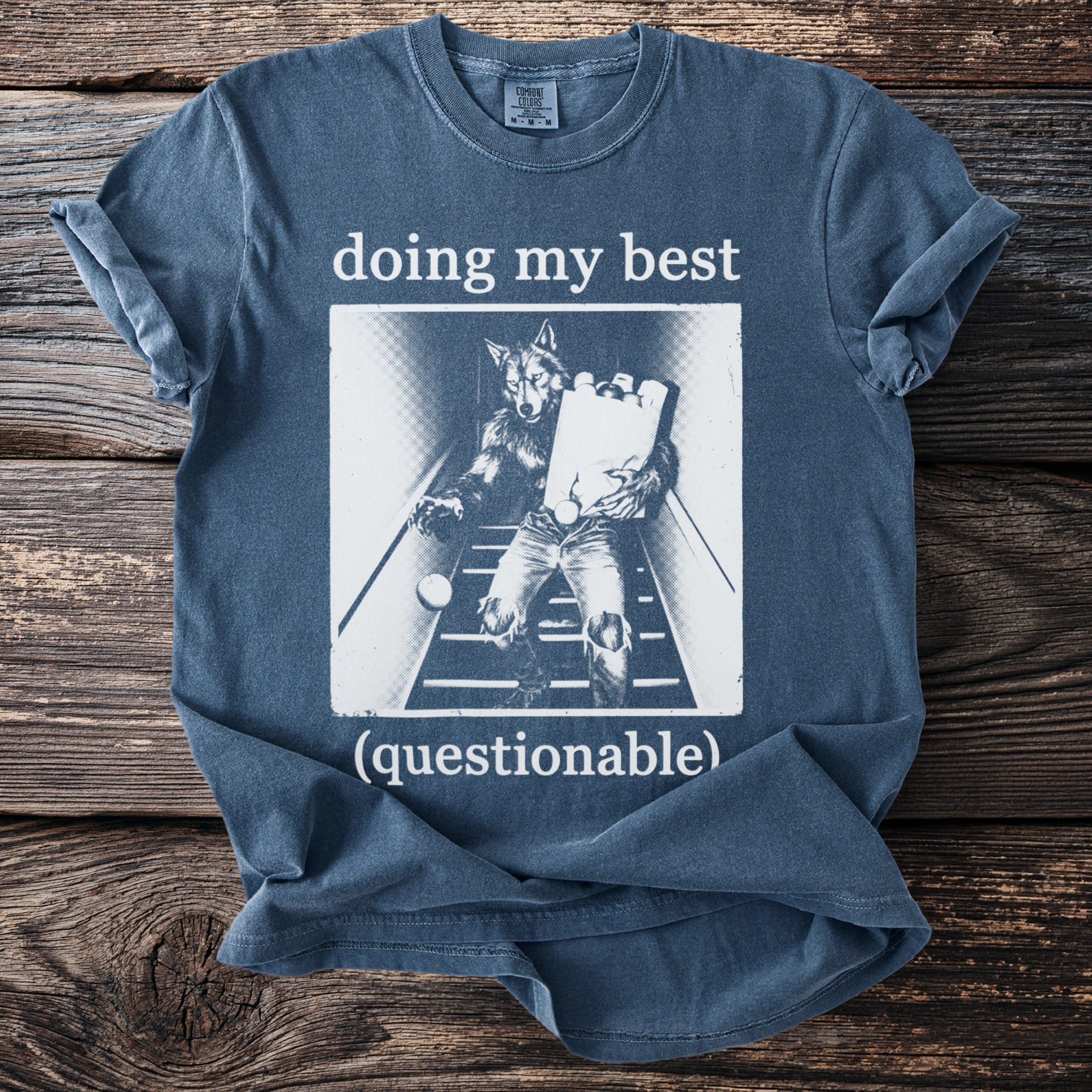Blue t-shirt with "doing my best (questionable)" text and werewolf graphic.