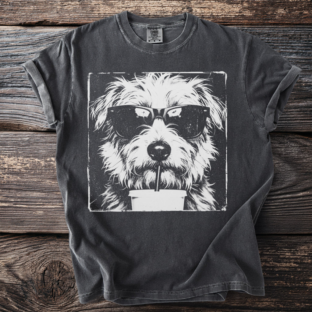 Black t-shirt with a white distressed graphic of a shaggy dog wearing sunglasses drinking from a cup.