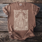 Brown t-shirt with a cream ink graphic of a warrior, ravens, and moon.