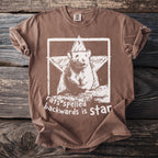 Brown t-shirt with a white graphic of a rat in a star and text reading "rats backwards is star".