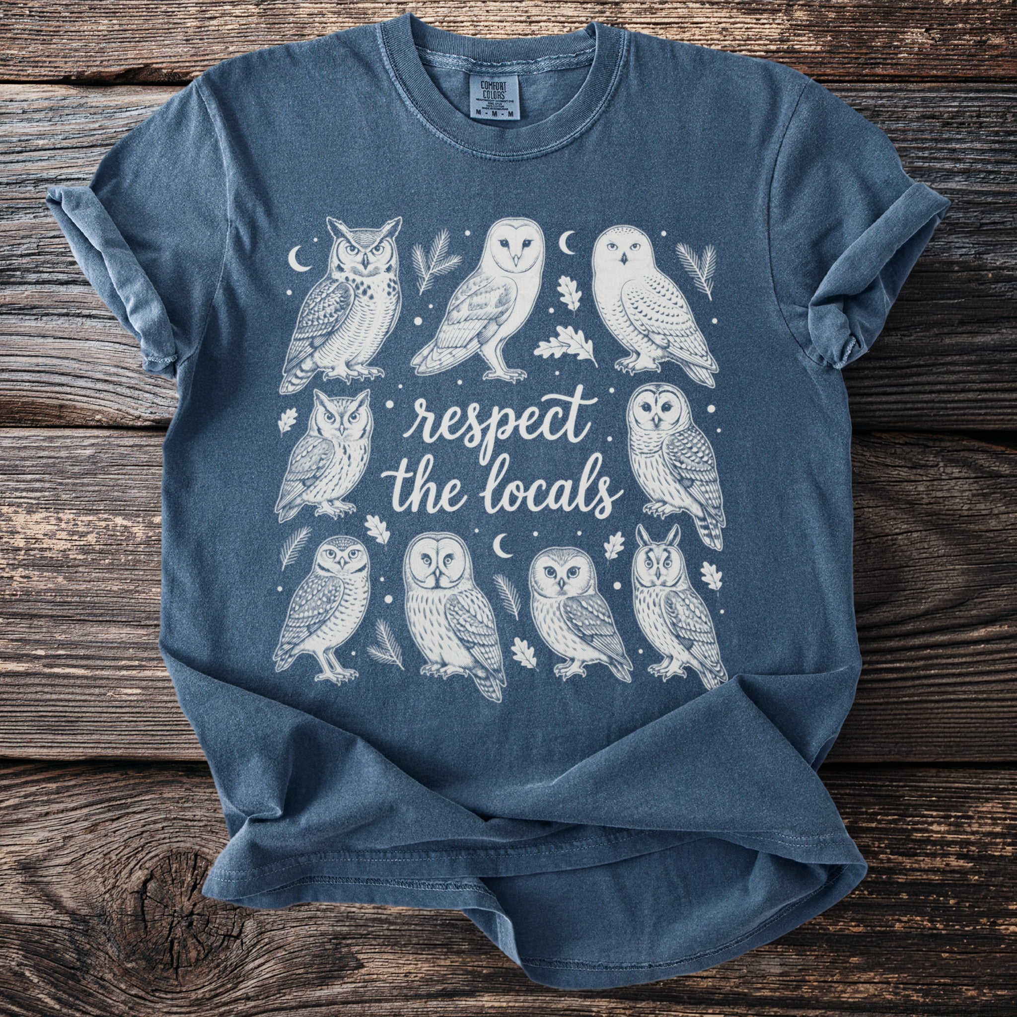T-shirt with illustrations of owls and the text "respect the locals".