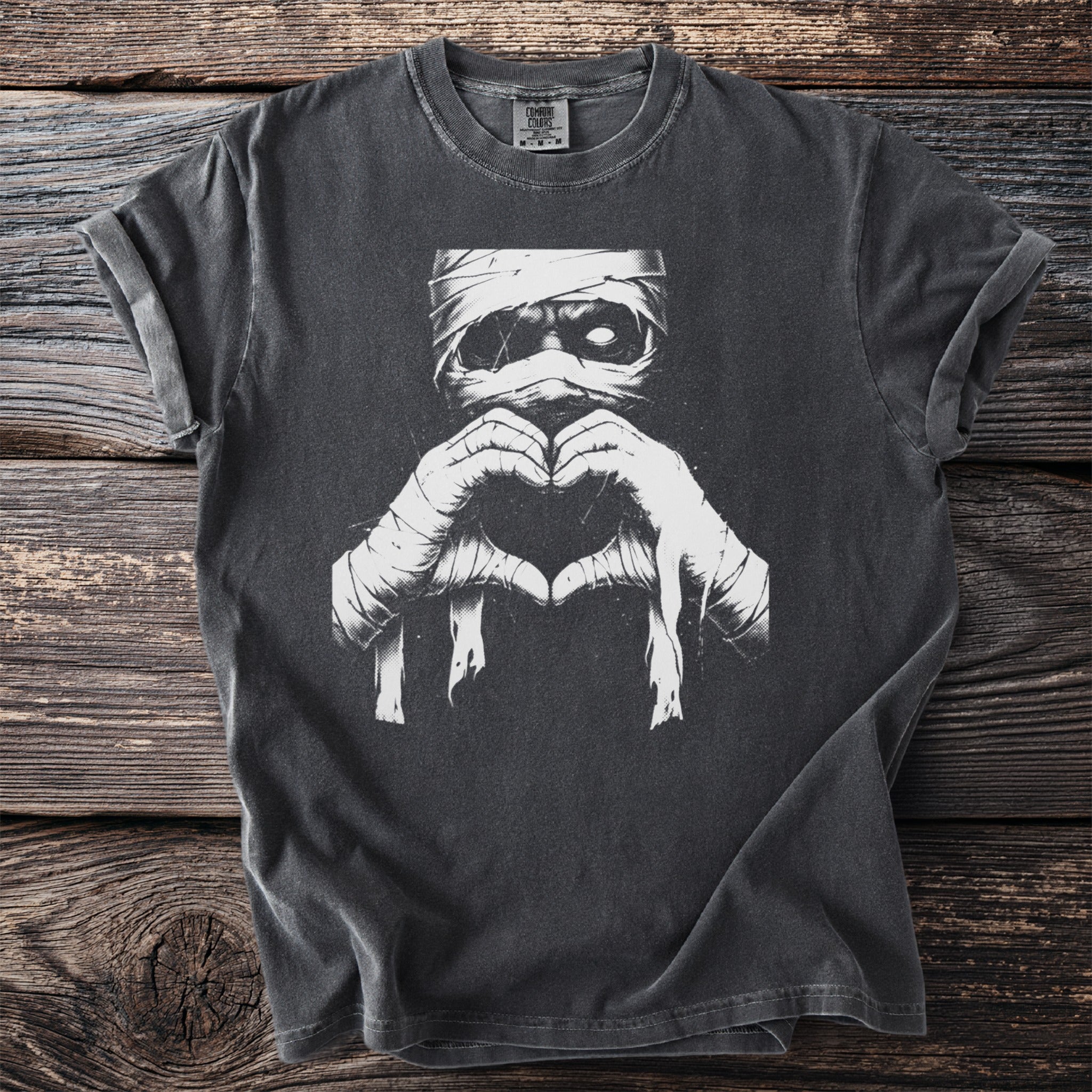 T-shirt with white mummy graphic making a heart shape with bandaged hands