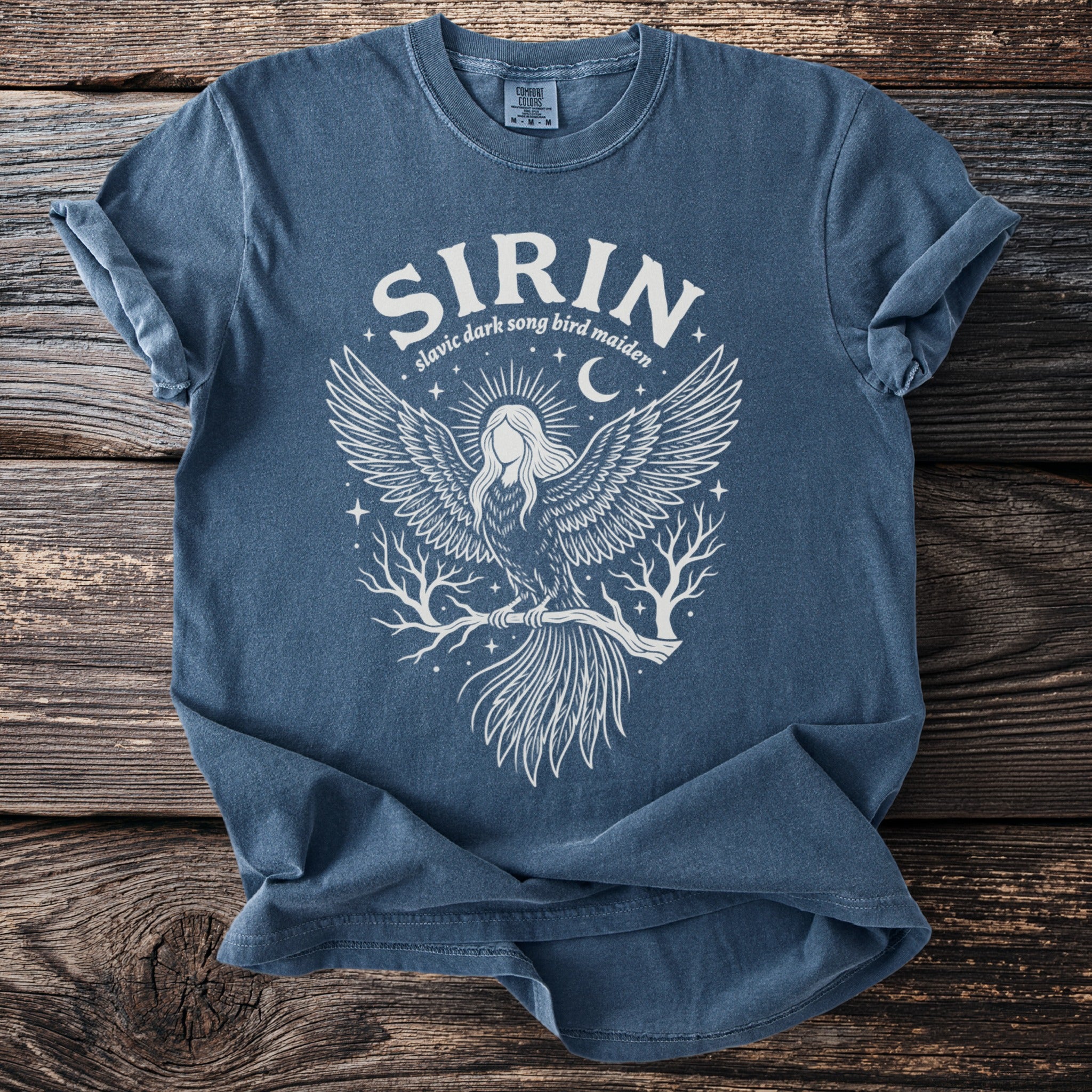 Blue t-shirt with white Sirin Slavic dark song bird maiden graphic and a crescent moon.