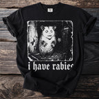 Black t-shirt with white graphic of a possum and text "i have rabies".