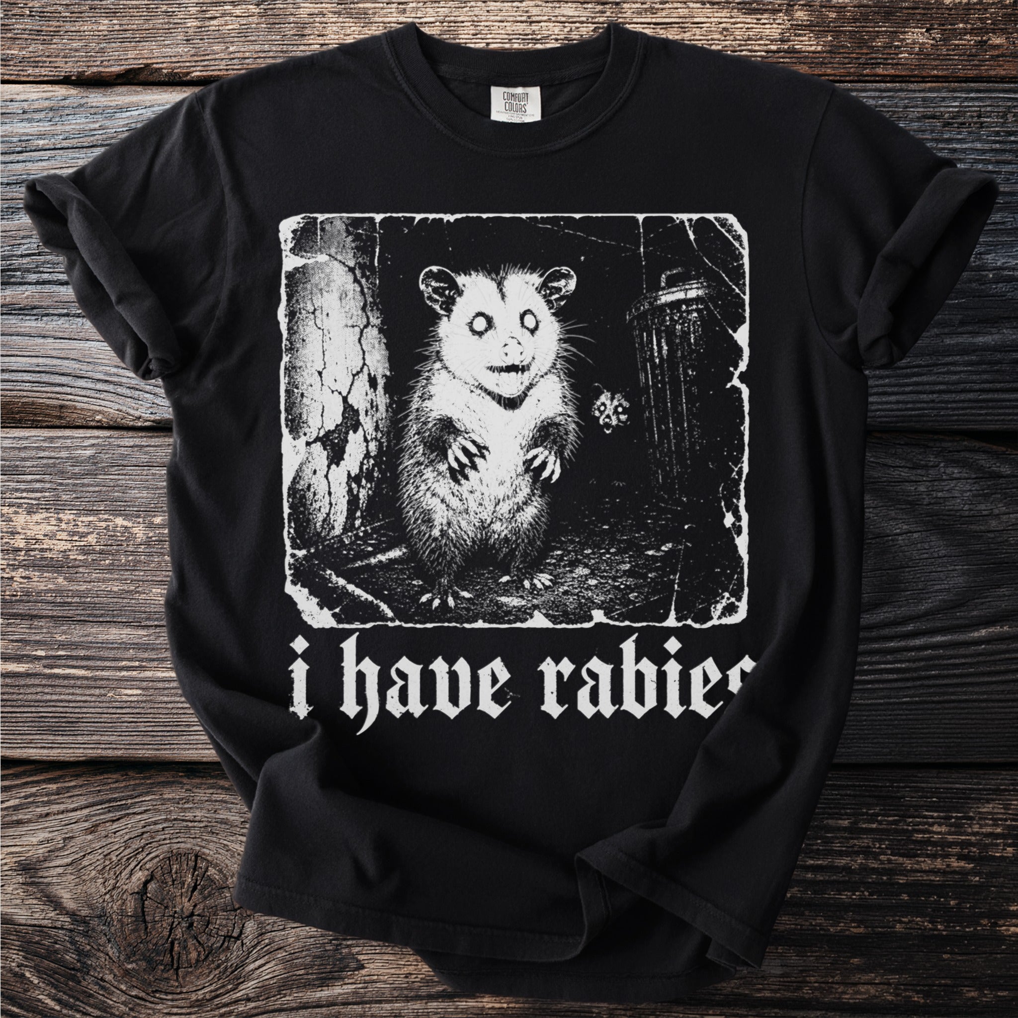 Black t-shirt with white graphic of a possum and text "i have rabies".