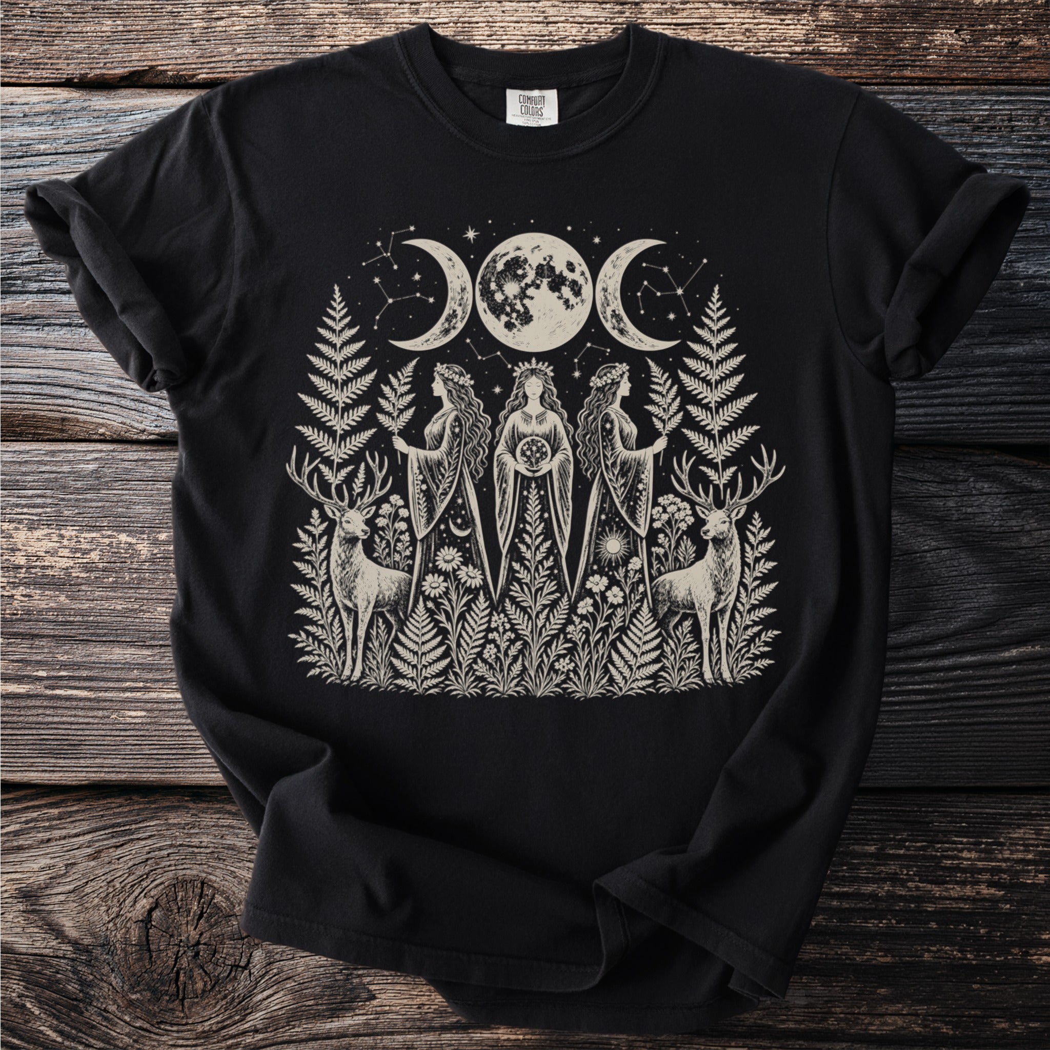 Black t-shirt with moon phases and three women in botanical forest setting.