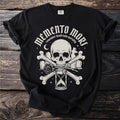 Black t-shirt with "Memento Mori" text, skull, bones, hourglass, rose, and gravestones.