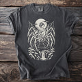 Spider web with geisha playing shamisen over waterfall and bridge graphic on black t-shirt.