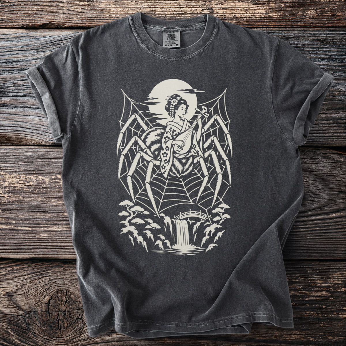 Spider web with geisha playing shamisen over waterfall and bridge graphic on black t-shirt.