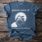 T-shirt with a pigeon graphic and text "patron saint of minding my own business."