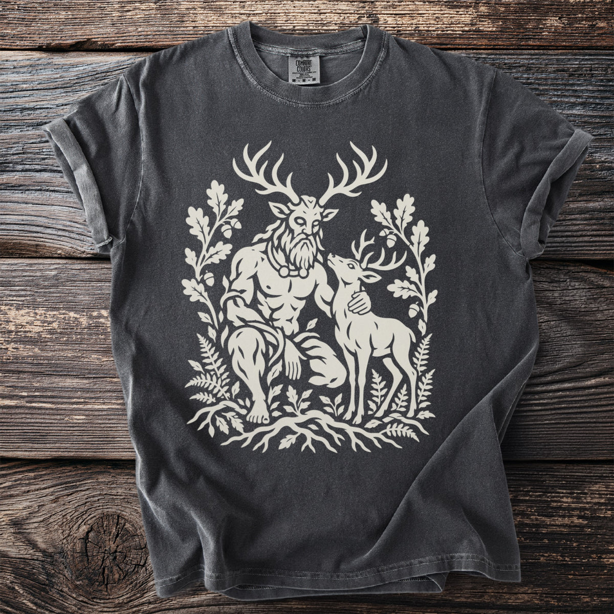 Dark gray t-shirt with a cream graphic of a horned man and a deer amidst foliage.