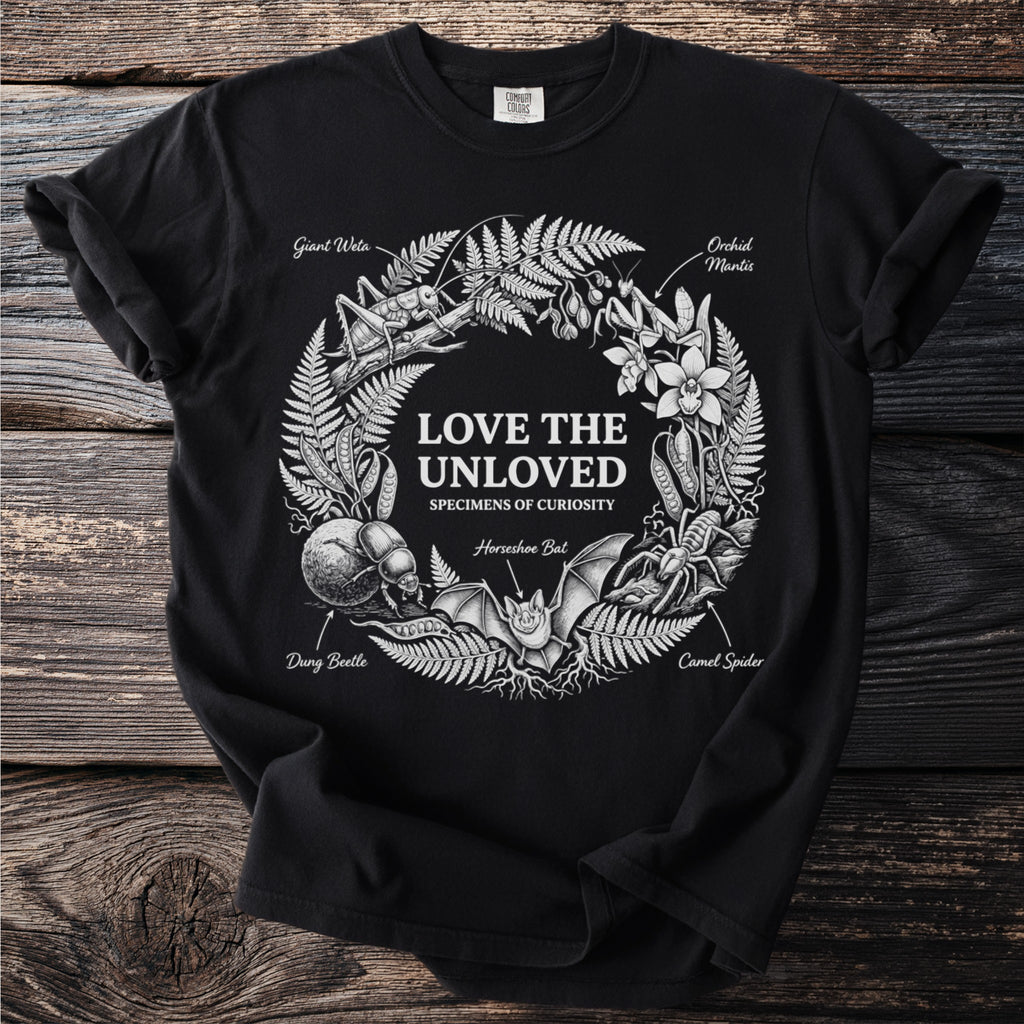 Black t-shirt with nature illustrations of insects and text "Love The Unloved Specimens Of Curiosity".