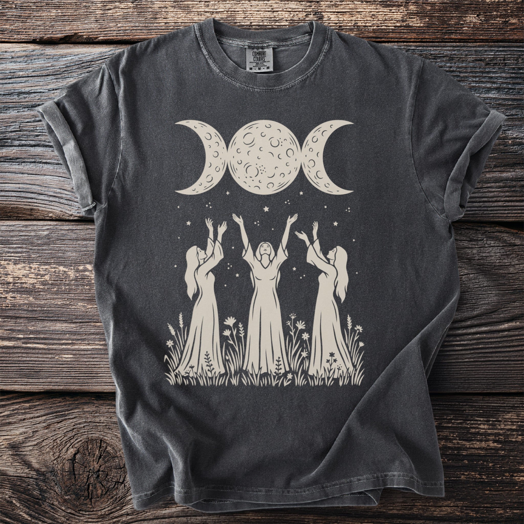 Dark grey t-shirt with graphic of three women, triple moon, and stars.