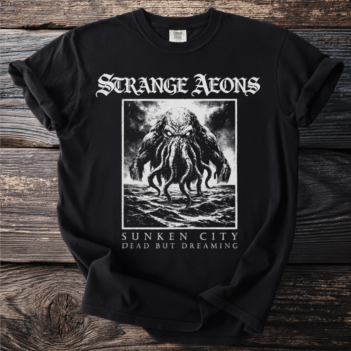 Black t-shirt with "Strange Aeons" and a creature with tentacles from the sea.