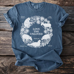Blue t-shirt with white line drawing of endangered animals encircled by plants and the text "LOVE THE UNLOVED".