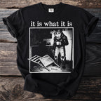 Black t-shirt with "it is what it is" and a werewolf in ripped jeans holding a mug.