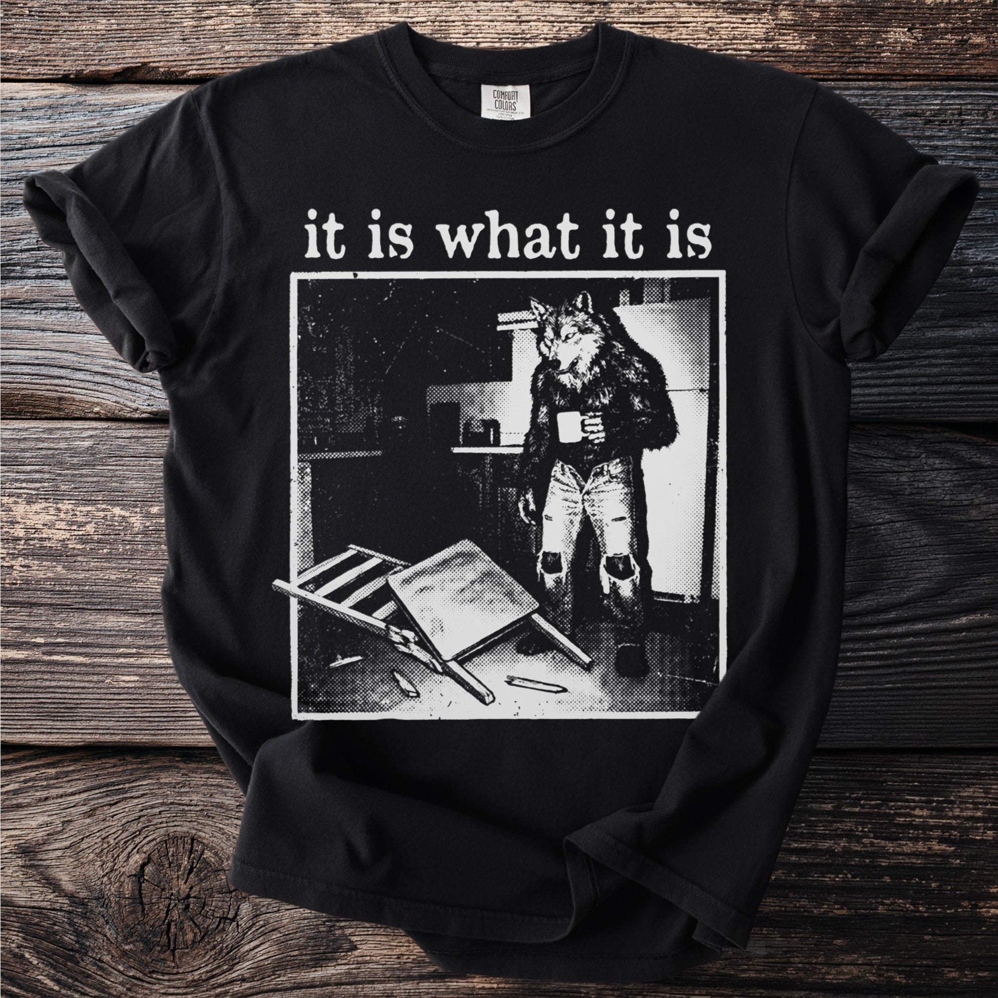 Black t-shirt with "it is what it is" and a werewolf in ripped jeans holding a mug.