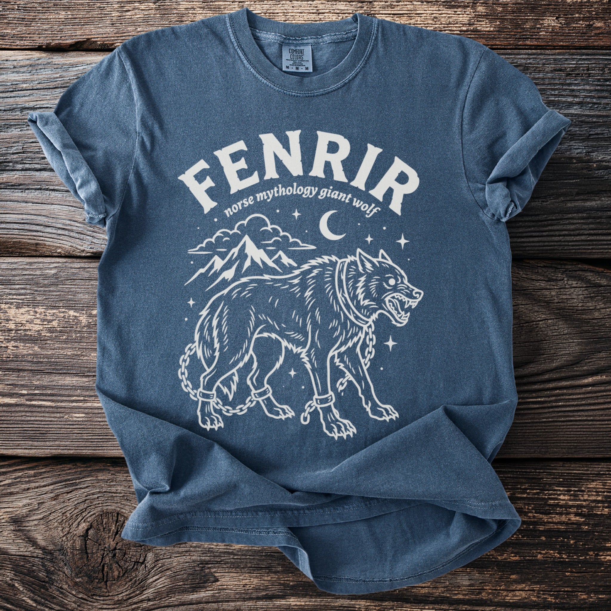Blue t-shirt with Fenrir Norse mythology giant wolf graphic and chains.