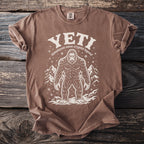 Brown t-shirt with white Yeti graphic and text "YETI himalayan snow cryptid legend".