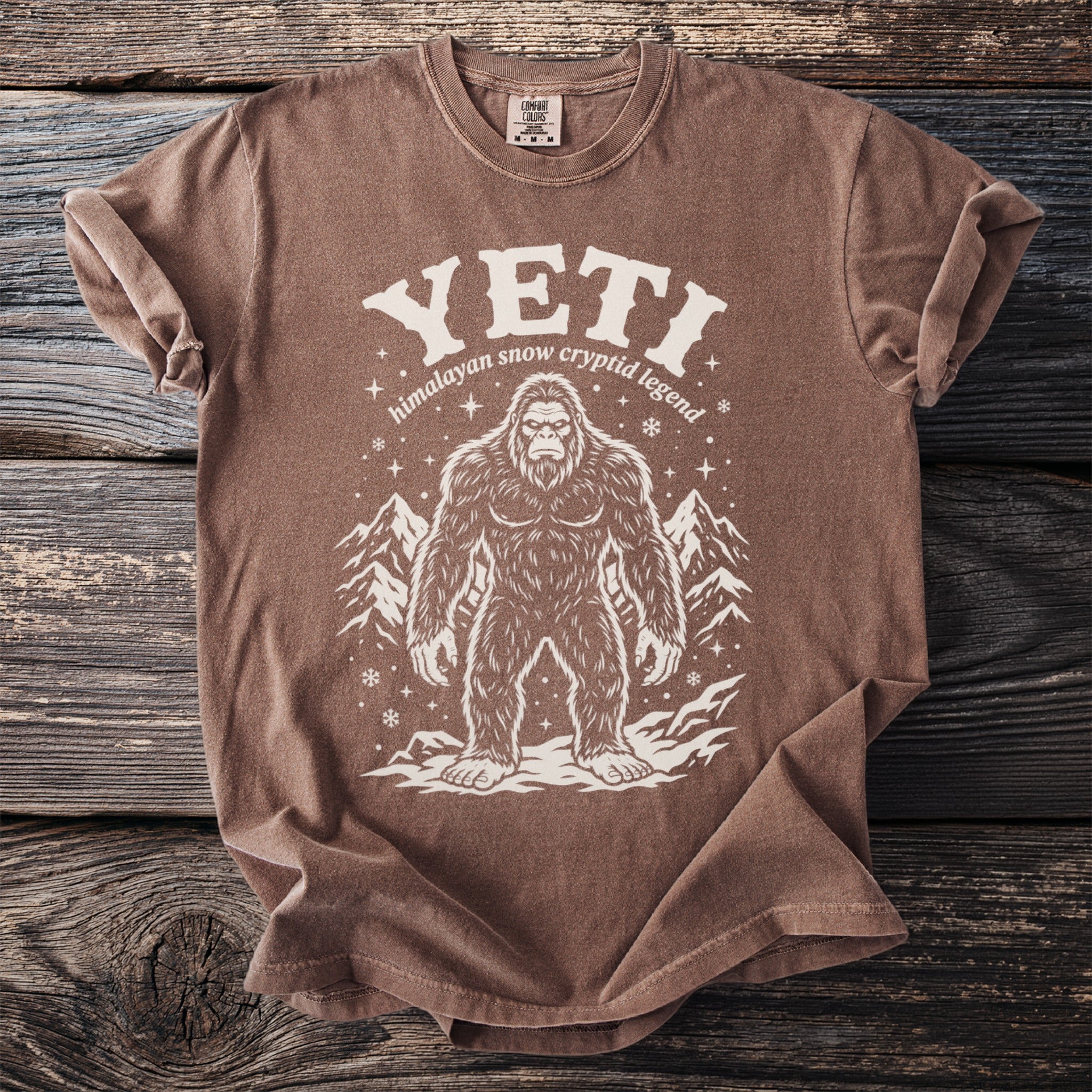 Brown t-shirt with white Yeti graphic and text "YETI himalayan snow cryptid legend".