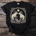 Black t-shirt with vintage style graphic of two goats under a sun.