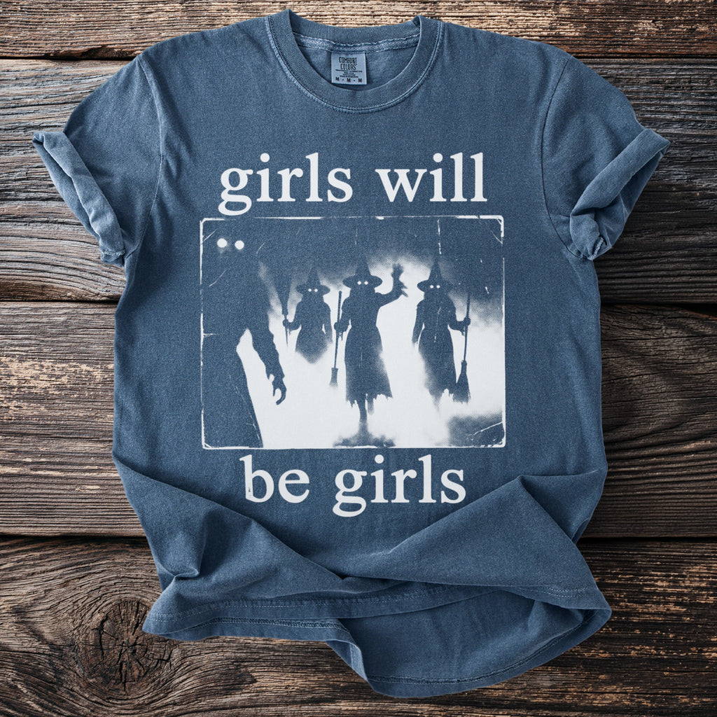 Blue t-shirt with graphic of witches and text "girls will be girls".