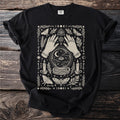 Black t-shirt with cream graphic featuring hands, crystal ball, moths, candles, and celestial symbols.
