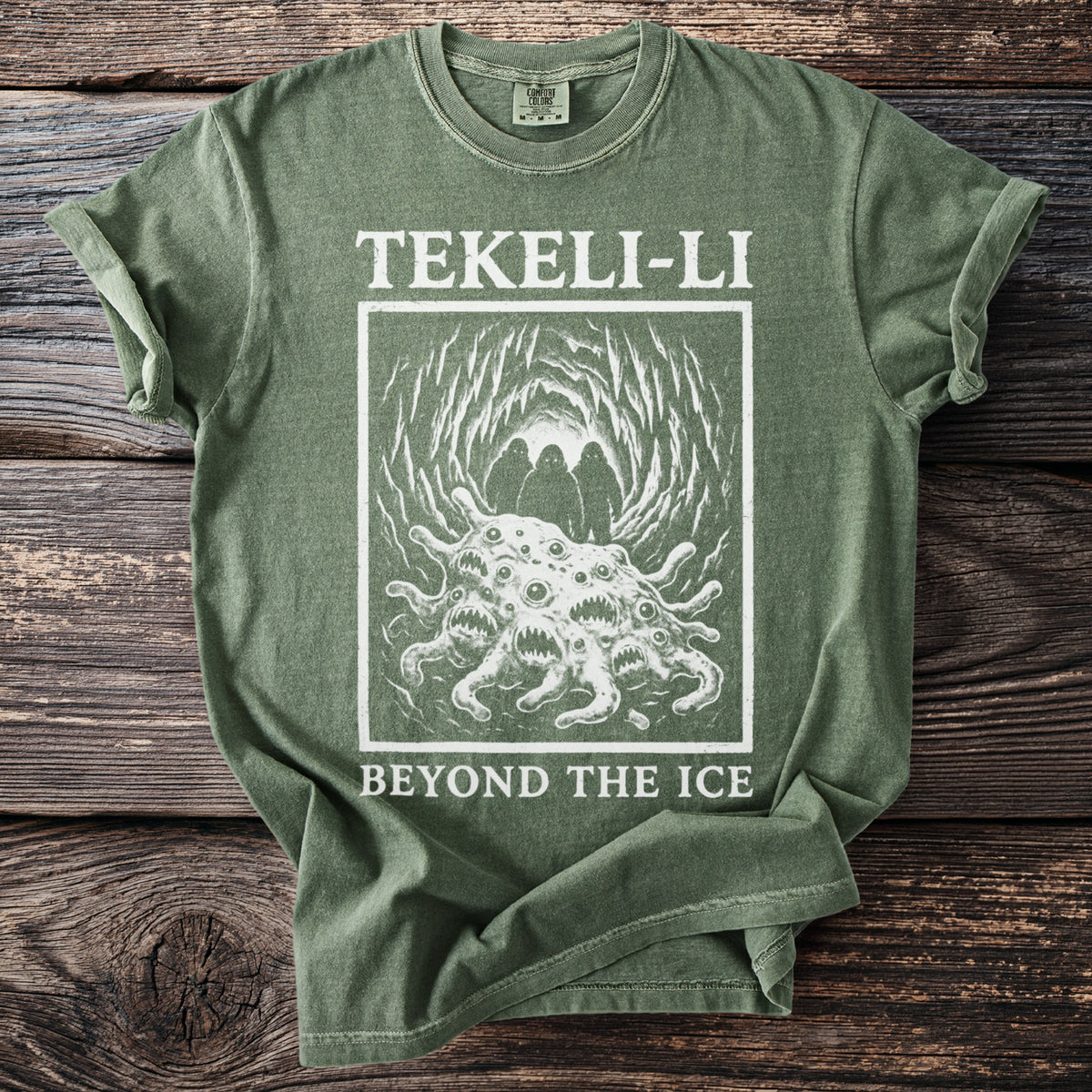 Green t-shirt with "TEKELI-LI BEYOND THE ICE" text and an illustration of a monster.