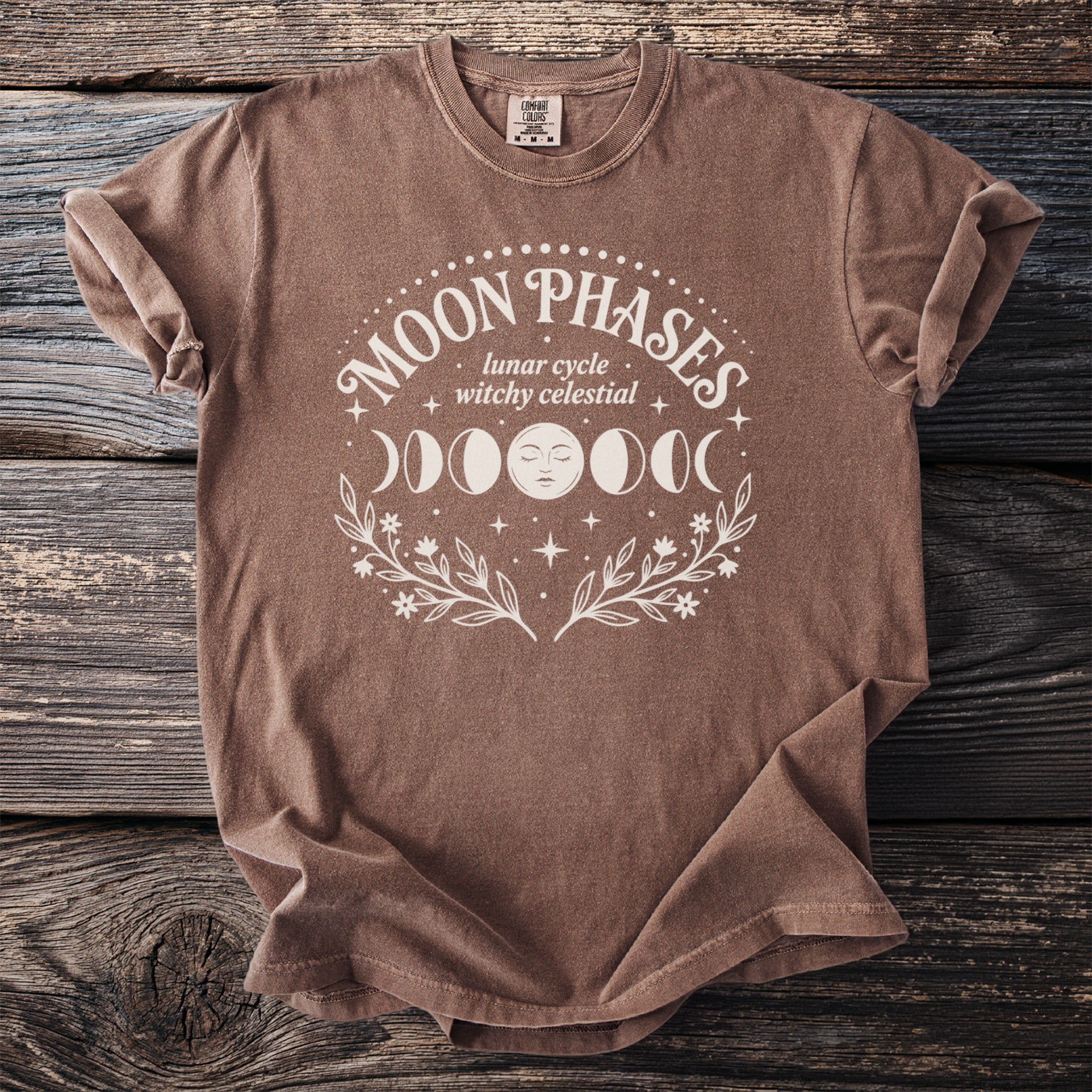 Brown shirt with white Moon Phases, lunar cycle, witchy celestial graphic.