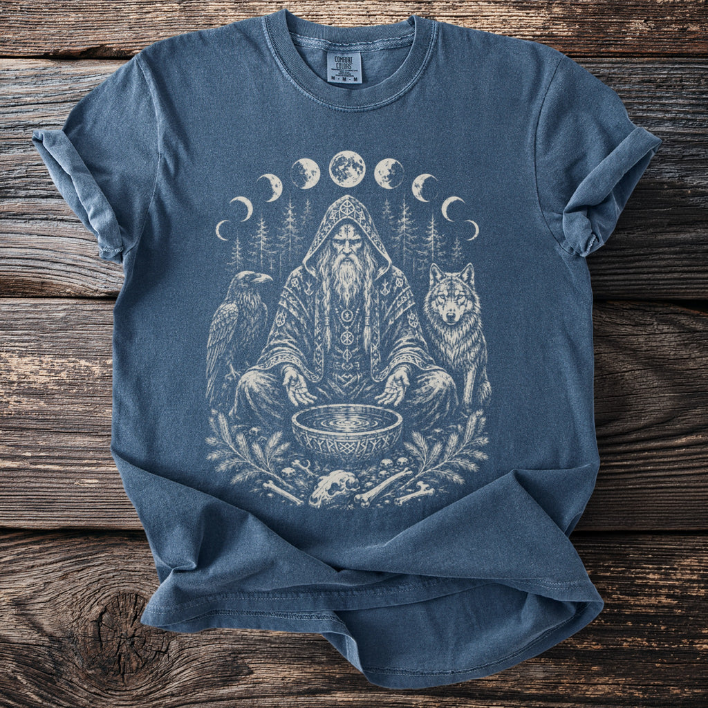 Blue t-shirt with shaman, wolf, raven, bones, and moon phases graphic.