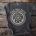 Dark grey t-shirt with "Find Your North" circular design featuring compass, snake, and trees.